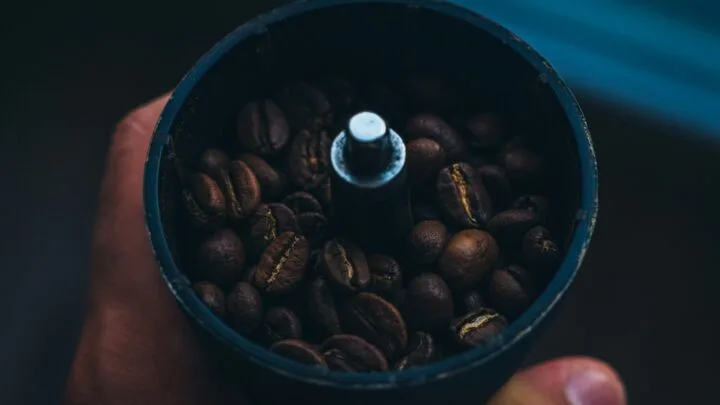Picture of decaf coffee beans in a coffee grinder for decaf cold brew coffee.