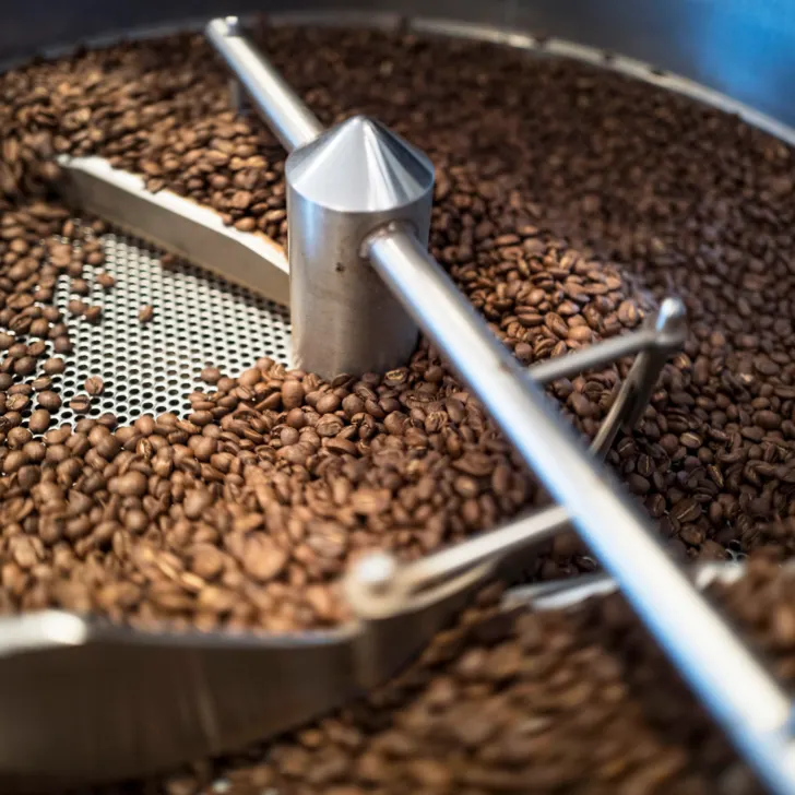 Picture of roasting coffee beans. Understanding The Relationship Between Roast Level and Coffee Acidity.