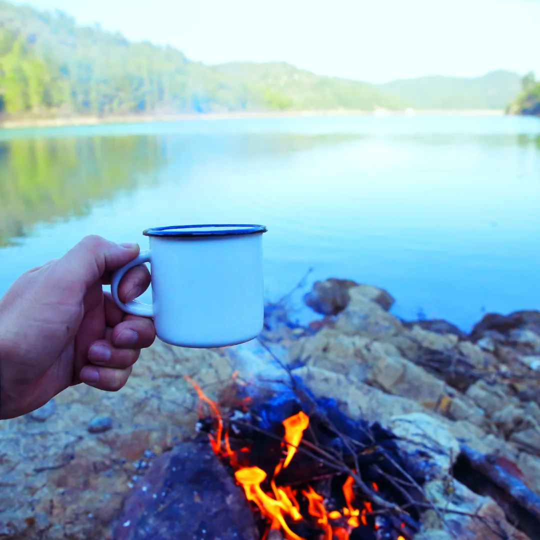 Enjoying a cup of coffee while camping. the best camping coffee grinder.