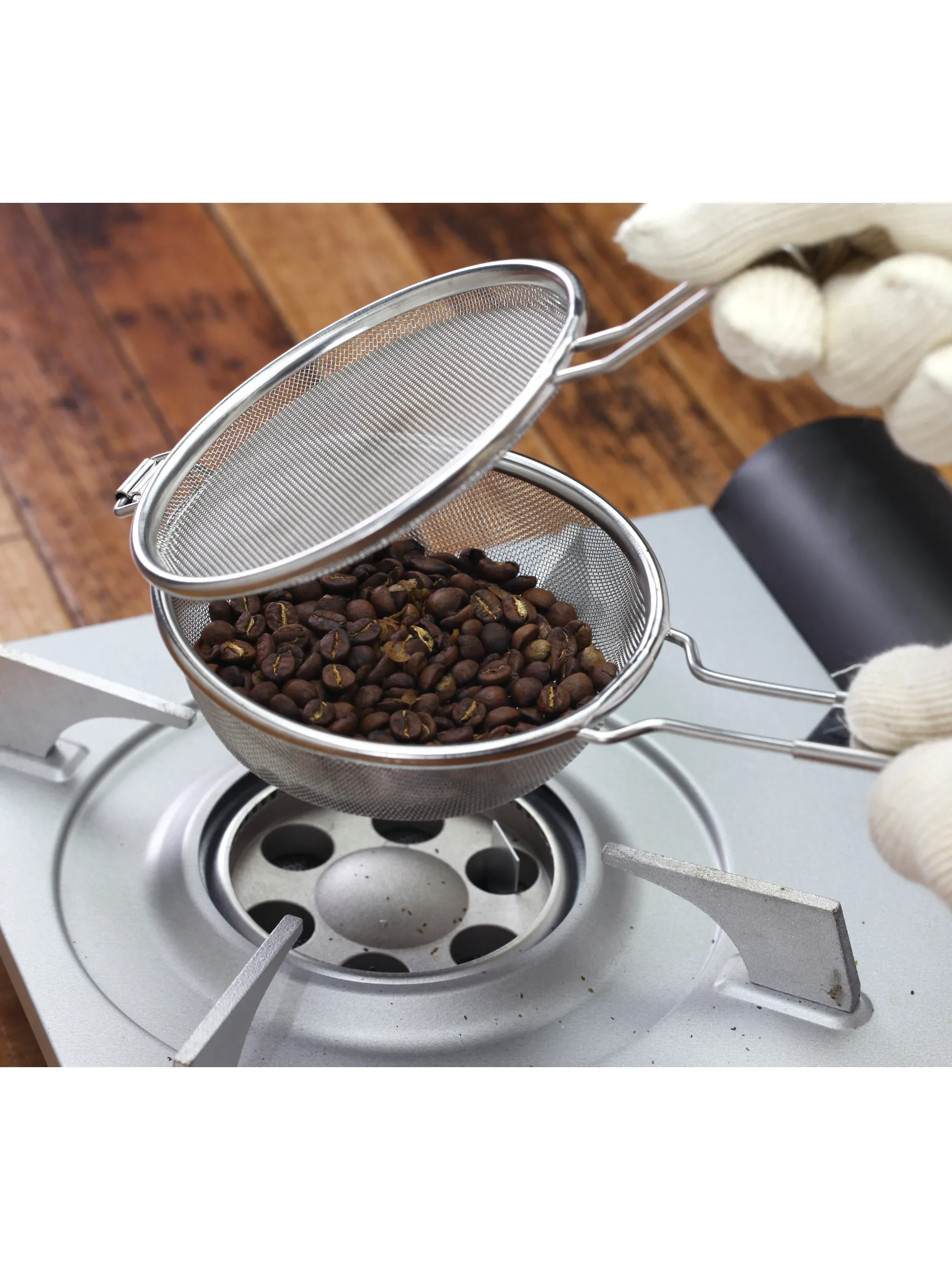 Image of person roasting coffee beans at home.