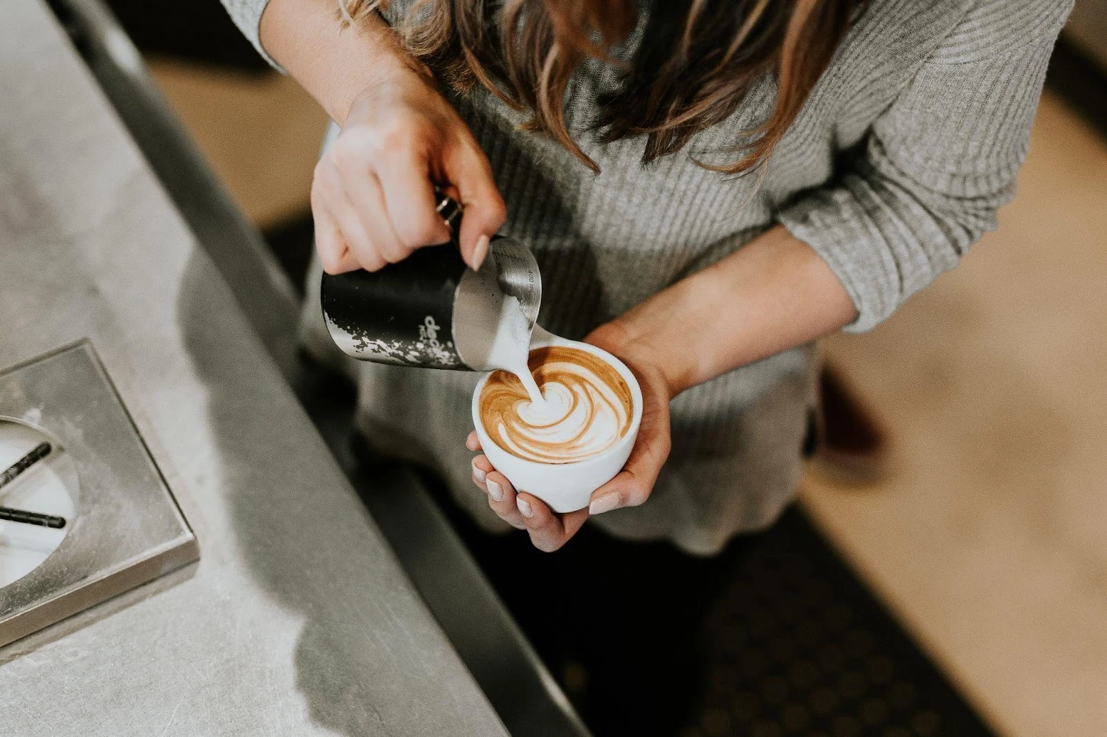 Picture of person pouring frothed creamer into a cup of coffee. Can you froth creamer?