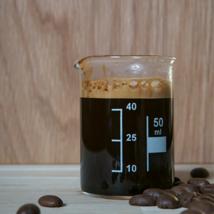 Image of coffee in a beaker. Can You Heat Up Cold Brew Coffee? From Brewing to Reheating